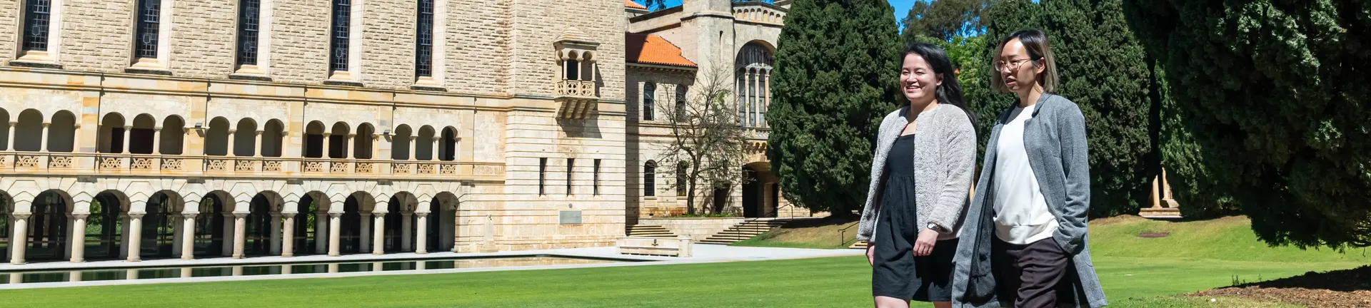 Staff walking in front of Winthrop Hall