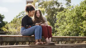 Two students sitting on stairs