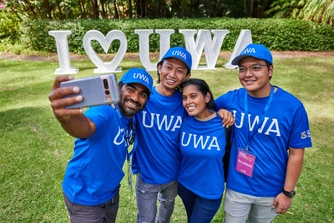 UWA staff volunteers at Open Day taking a selfie in front of the 'I love UWA' signage.