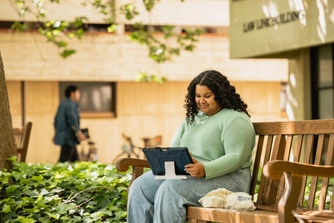 Student outside the Law building